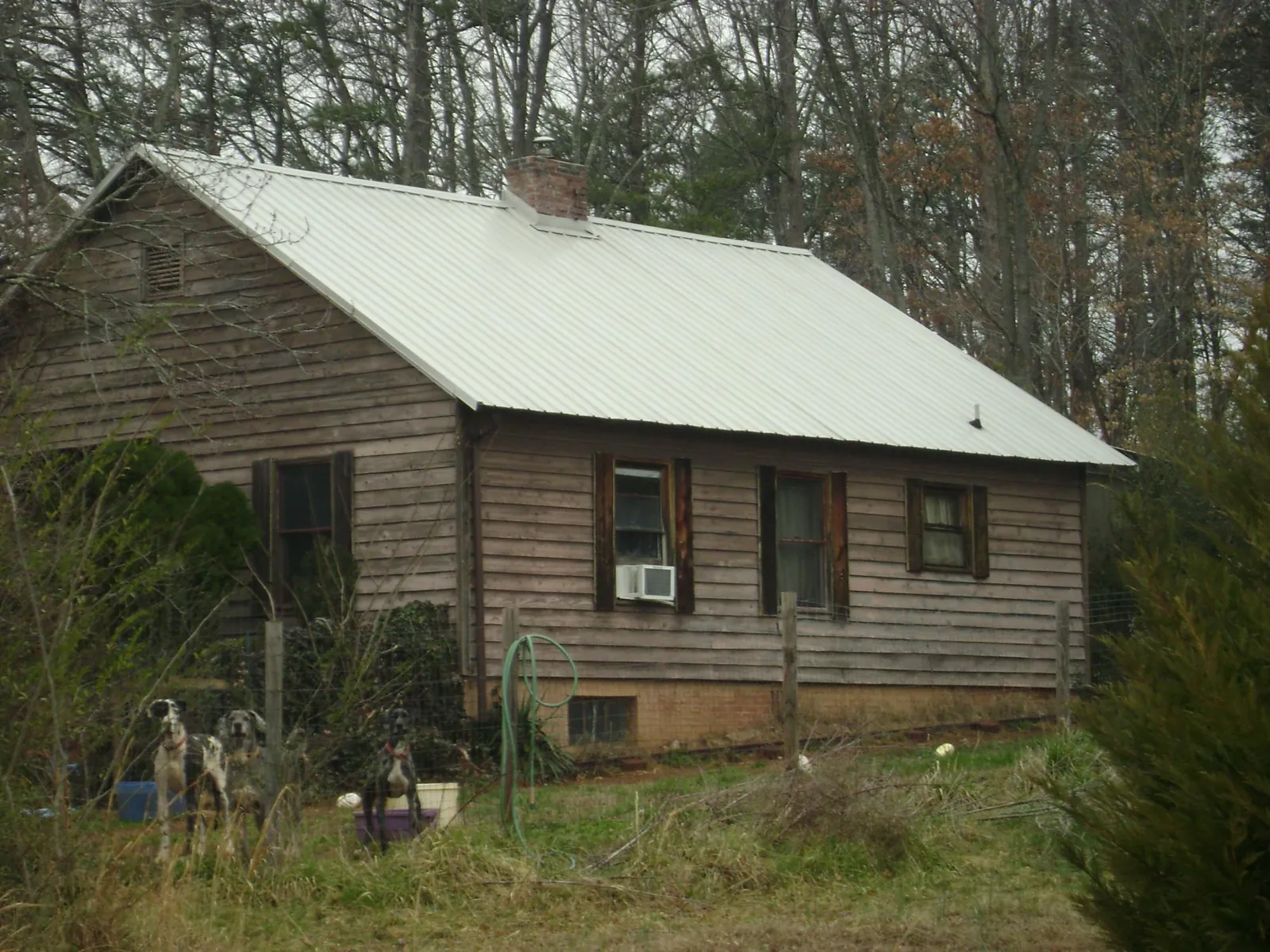 White metal roof on an old wood sided farmhouse, from a Metal Roof Installation job in Keyesport